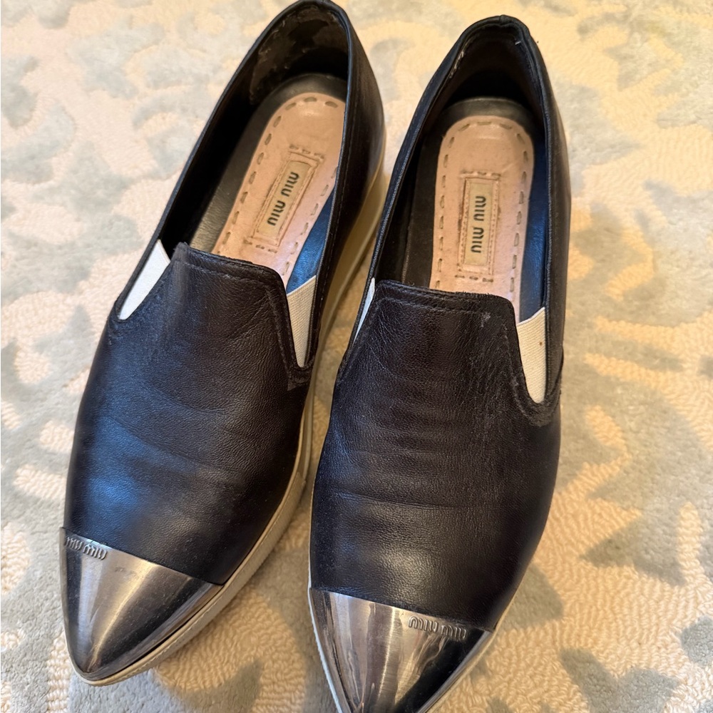 Miu Miu Black Leather Slip-Ons with Metallic Silver Toe